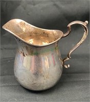 Small sterling silver creamer measures 3 1/2