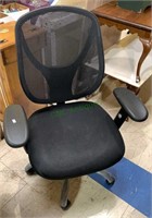 Black office chair with a mesh back with three