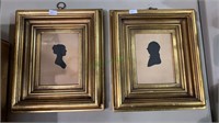 2 gold framed silhouettes - one of a woman, the