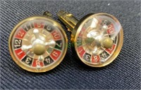 One pair of gold tone roulette wheel cufflinks
