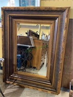 Extra large gold framed wall mirror with a