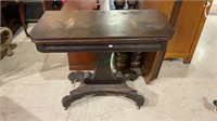 Antique gaming table on caster wheels, some