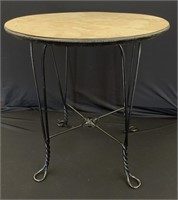 Small round table with twisted iron legs and a woo