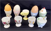 Lot of 9 assorted ceramic egg cups in a variety of