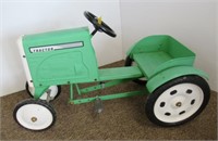Green pedal tractor.
