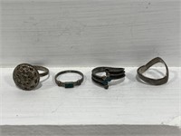 Four various silver tone rings. #241