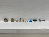 A group of nine small pendants / charms. #361