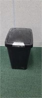 Black plastic flip top 8 gallon trash can