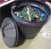 Plastic trash can full of used Christmas