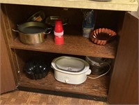Small appliances and cookware in lower cabinet