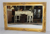 large mirror with gold wooden frame