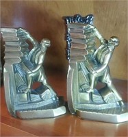 Man stacking books Brass bookends nice heavy