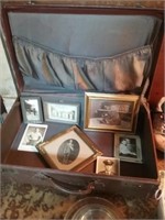 Vintage suitcase with old frame photos