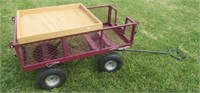 Rolling metal garden cart. Measures 20.5" H x 38"