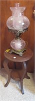 Vintage wood plant stand with hurricane lamp.