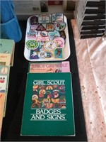 Two Girl Scout books and a tray of patches