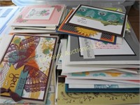 assorted hand made greeting cards in storage bin