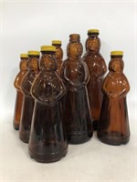Seven vintage brown glass Aunt Jemina bottles