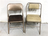 Two padded seat metal folding chairs