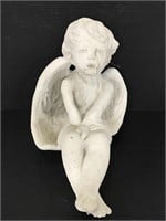 Carved stone sitting angel