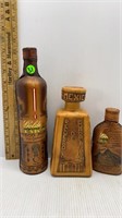 3-ALCOHOL BOTTLES WRAPPEN IN CARVED LEATHER