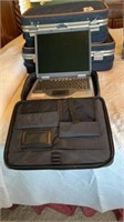 Compac laptop with cords and travel case.