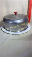 Vintage aluminum cake topper with milk glass cake