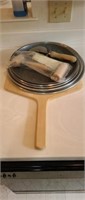 Assorted pizza pans, upper trust board, dough and