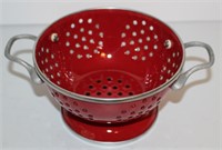 small red enamelware colander