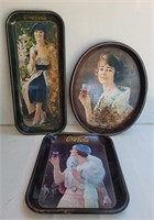 Vintage Coca-Cola trays.  Some with rust.
