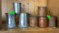 4 copper mugs with brass handles, 3 pewter cups,