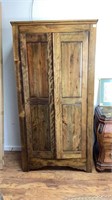 Wooden wardrobe style storage or display shelf.