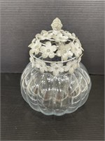 Decorative glass jar with metal flower lid