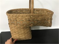 Brown wicker basket for stairway with teal pattern
