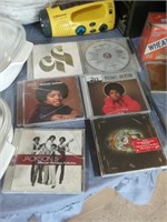 Group of six Jackson music CDs