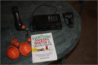 Sling shot, dvd player, flashlight, book, decor