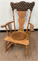 Antique oak rocking chair with a round oak