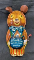 Vintage wind up music playing teddy bear tin toy.