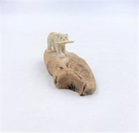 Moose antler carving of a bear with its dinner on