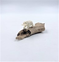 Moose antler carving of a bear with its dinner on