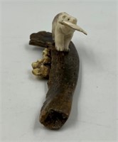 moose antler carving of a bear on a fossilized can