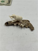 Moose antler carving of a bear w/lunch on a fossil