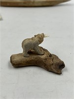 Moose antler carving of a bear with dinner on a fo