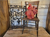 A chicken a chair and a wall hanging