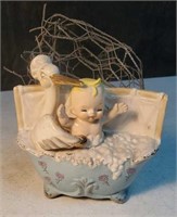 Baby in bathtub with stork planter