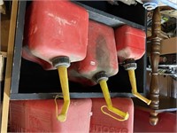 three plastic gas cans