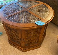 Round top wood end table, carved wood under glass