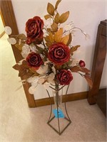 Floral arrangement in glass and metal stand vase