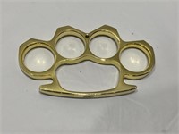 Brass knuckles toned paperweight with belt buckle