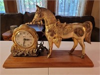 United brass mantle clock with horse statue.